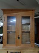 An antique pine double door bookcase