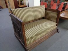 A late 19th century carved oak framed hall settee