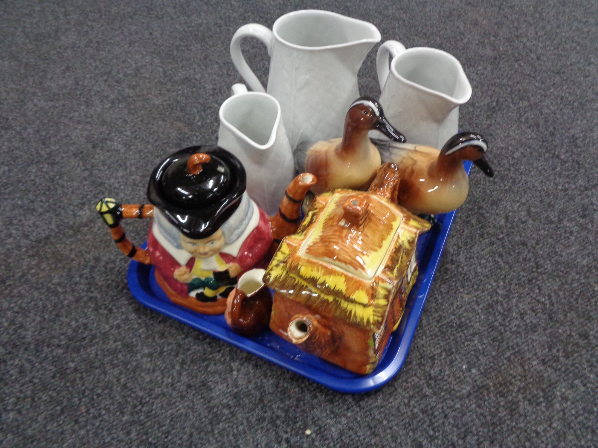 A tray of three Royal Worcester graduated jugs, Price Brothers teapot, character jug teapot,