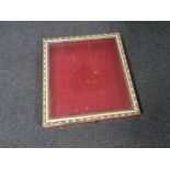 A gilt framed counter topped display cabinet with red velvet lining