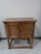 A Jaycee Oak cabinet fitted with three drawers on raised legs