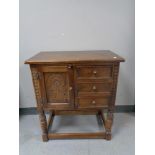 A Jaycee Oak cabinet fitted with three drawers on raised legs