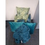 Two boxes of six turquoise cushions and a throw