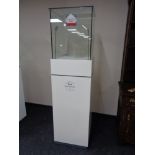 A square jeweller's shop display cabinet with internal lights, cupboards beneath,