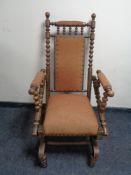 An oak American style rocking chair