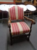 A 20th century carved armchair upholstered in a striped fabric