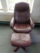 A brown leather relaxer chair and stool