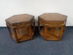 A pair of hexagonal two tier lamp tables with brass mounts