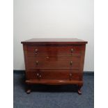 A 20th century three drawer chest in a mahogany finish