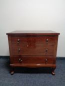 A 20th century three drawer chest in a mahogany finish