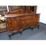 A Victorian mahogany serpentine fronted sideboard on claw and ball feet