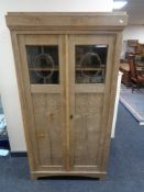 An early 20th century oak double door bookcase