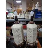 A pair of cream hexagonal pottery table lamps on wooden bases
