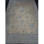 A blue floral carpet on cream ground