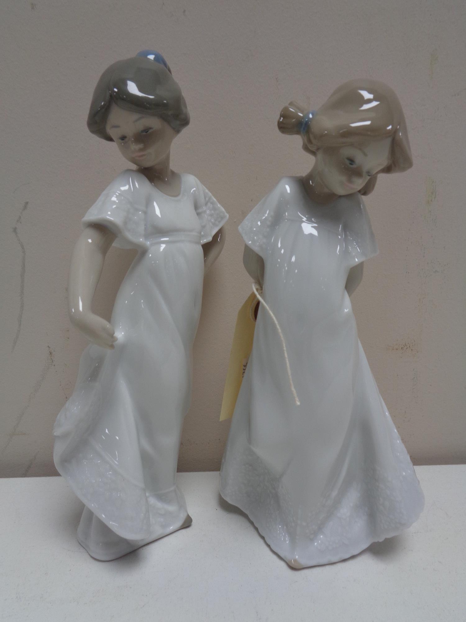 Two Nao figures - Girl in night dress no. 1109 1110.