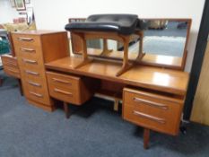 A teak G Plan four piece bedroom suite comprising knee hole dressing table, stool,