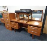 A teak G Plan four piece bedroom suite comprising knee hole dressing table, stool,