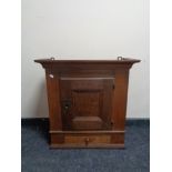 An antique oak wall cabinet fitted a drawer