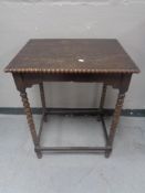 An Edwardian oak occasional table