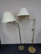 A pair of contemporary floor lamps with shades