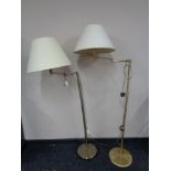 A pair of contemporary floor lamps with shades