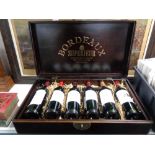 A wine casket containing six bottles of Bordeaux Superieur wine