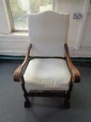 A carved oak scroll arm armchair