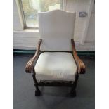 A carved oak scroll arm armchair