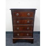 A reproduction mahogany four drawer chest