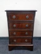 A reproduction mahogany four drawer chest