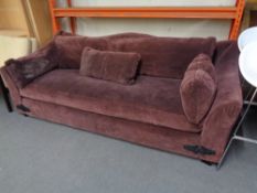 A large settee with cushion in purple fabric CONDITION REPORT: Approximately 240cm