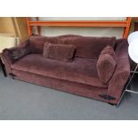 A large settee with cushion in purple fabric CONDITION REPORT: Approximately 240cm