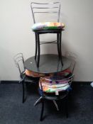 A circular marble topped bistro table on metal legs,