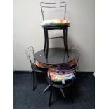 A circular marble topped bistro table on metal legs,