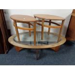 A mid 20th century oval teak coffee table and pair of matching side tables