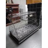 A folding metal dog cage,