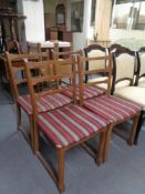 A set of four oak rail back dining chairs