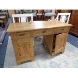 An early 20th century oak twin pedestal writing desk CONDITION REPORT: 125cm wide