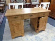 An early 20th century oak twin pedestal writing desk CONDITION REPORT: 125cm wide