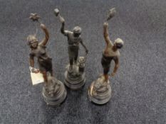 Three French spelter figures on wooden stands