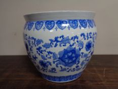 An Oriental style fish bowl planter together with a drum stool