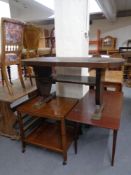 A mahogany flap sided coffee table together with a further coffee table and a two-tier trolley