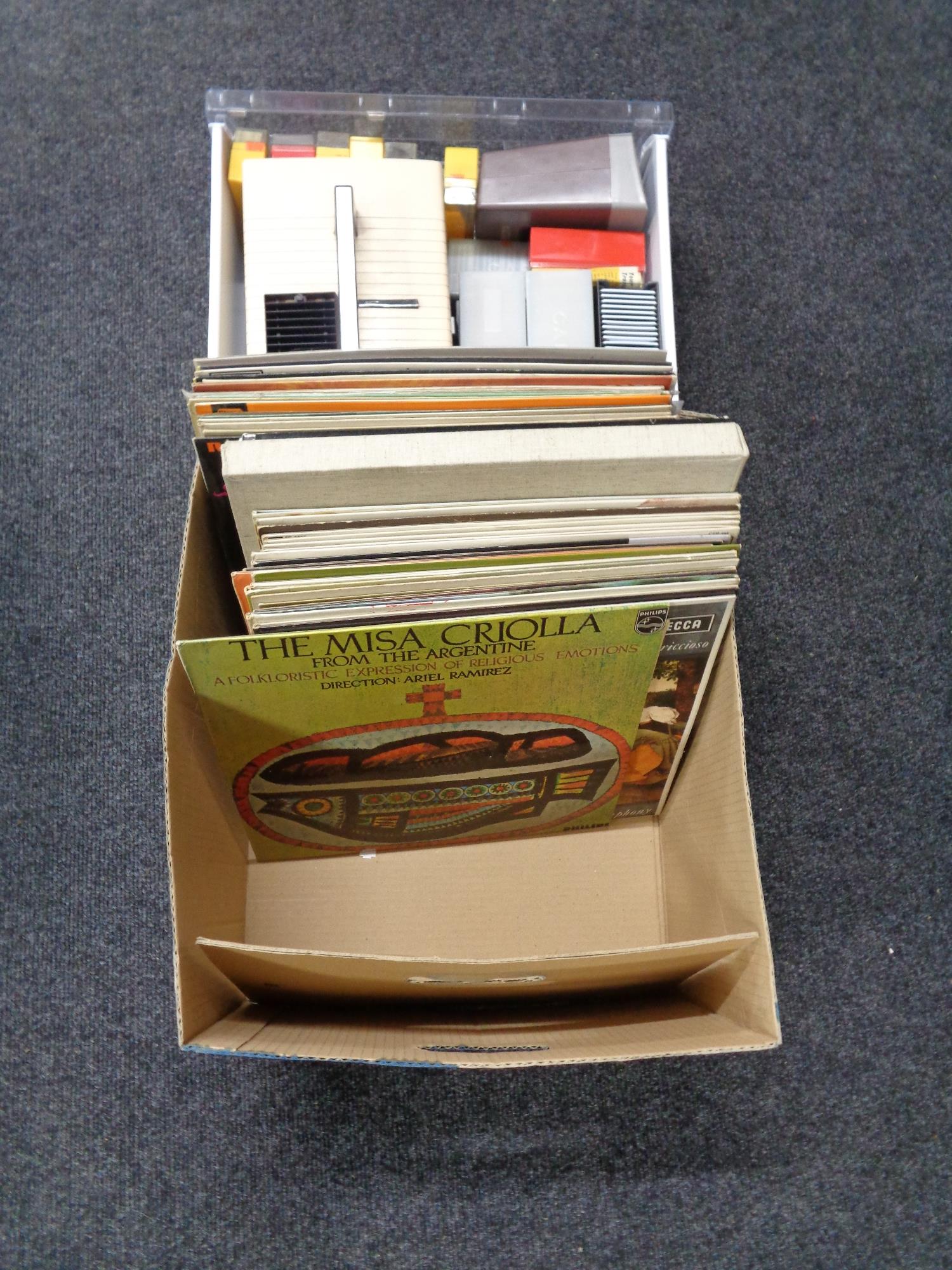 A box of lps, pictures, projector,