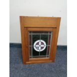 An oak wall cabinet with leaded glass doors