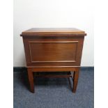 An early 20th century two division cabinet on raised legs