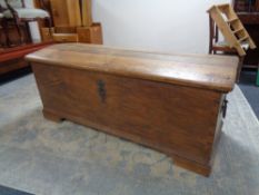 A 19th century oak domed topped shipping trunk, width 147 cm, height 58 cm and depth 65 cm.
