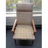 A mid 20th century Danish teak framed armchair in brown fabric