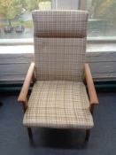 A mid 20th century Danish teak framed armchair in brown fabric