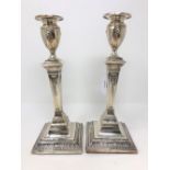 A pair of Edwardian Neo-Classical loaded silver candlesticks, Walter Latham & Son, Sheffield 1902,