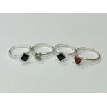 Four silver gem set rings